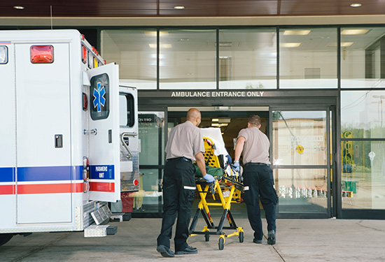 Ambulance at the hospital with a man on a stretcher